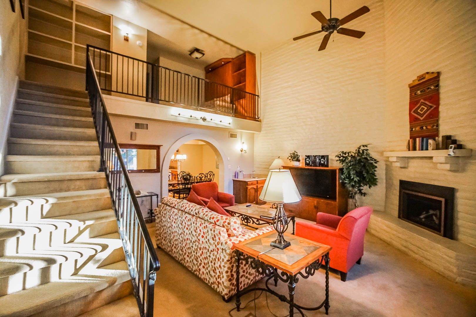 A vibrant living room, and a view of the upstairs bedroom at VRI's Villas of Sedona in Arizona.